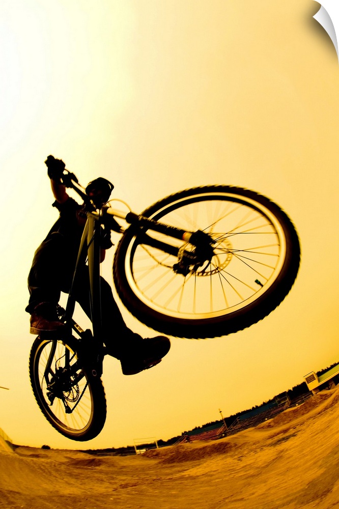 Silhouette Of A Cyclist Against A Yellow Sky