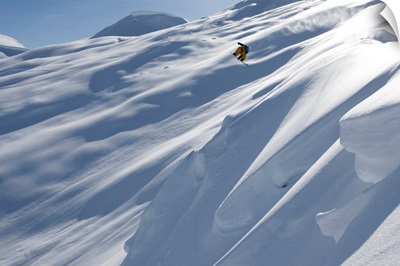 Snowboarder heli boarding in the mountains above Haines, Alaska