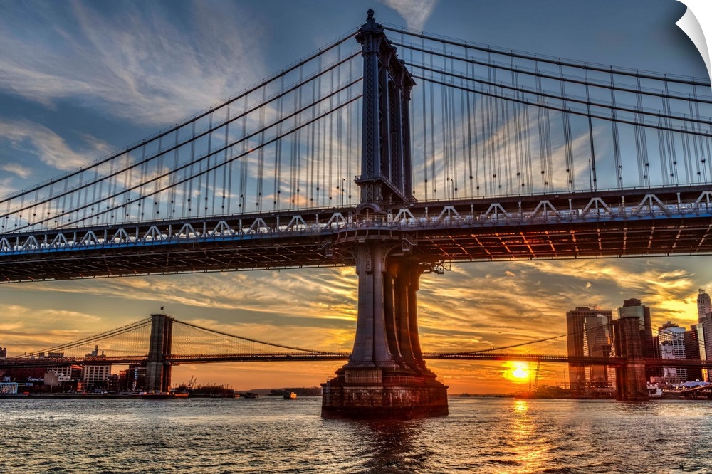 Sun setting behind Manhattan and Brooklyn Bridges; New York City, New York, United States of America