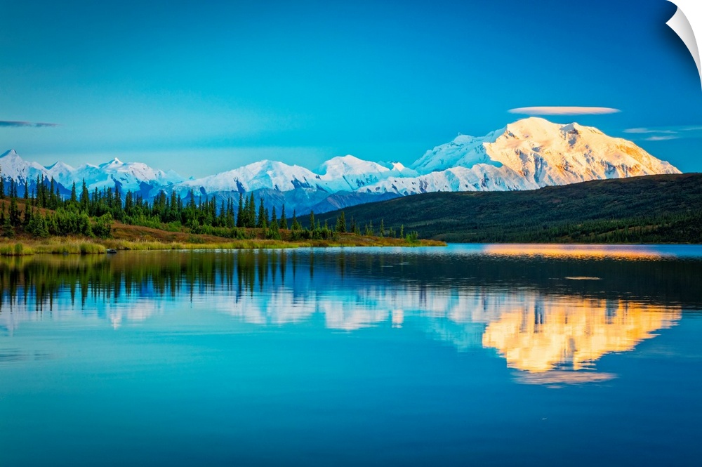 Sunset glow on Mount Denali (McKinley) reflects on Wonder Lake in autumn in Denali National Park and Preserve, Interior Al...
