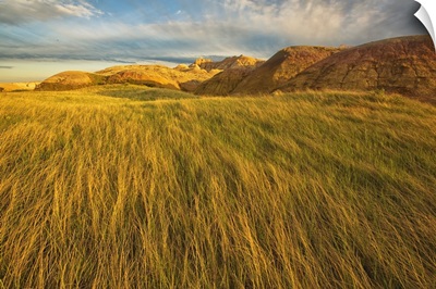 Sunset over the grass and mud formations in Badlands National Park, South Dakota