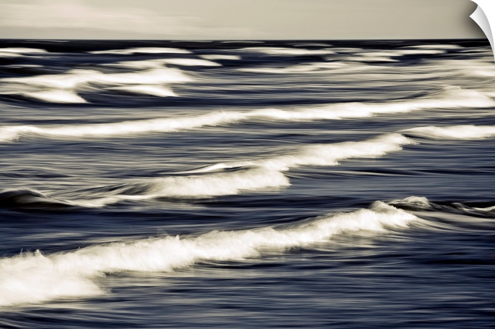 Big photo on canvas of waves breaking up close in the ocean.