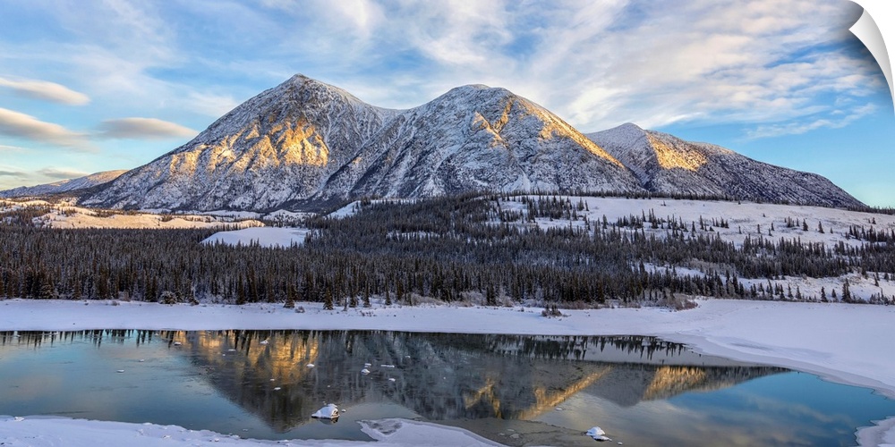 Late winter afternoon light warms up the mountains along the Takhini River, near Whitehorse. Yukon, Canada.