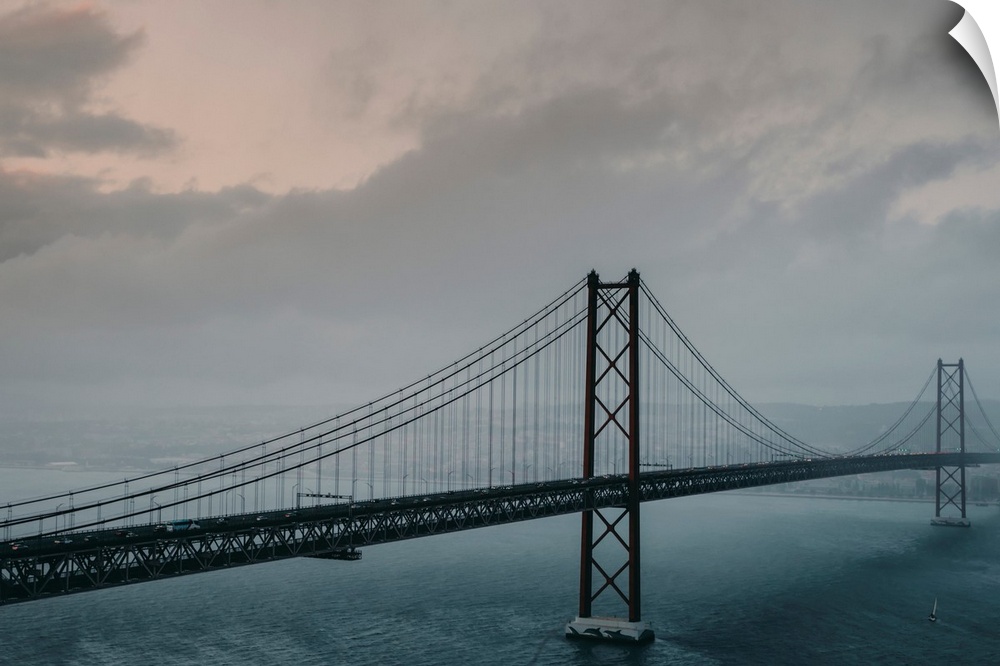 The 25 de Abril Bridge crossing the Tagus River, connecting Lisbon and Almada on a grey, foggy day, Lisbon, Estremadura, P...