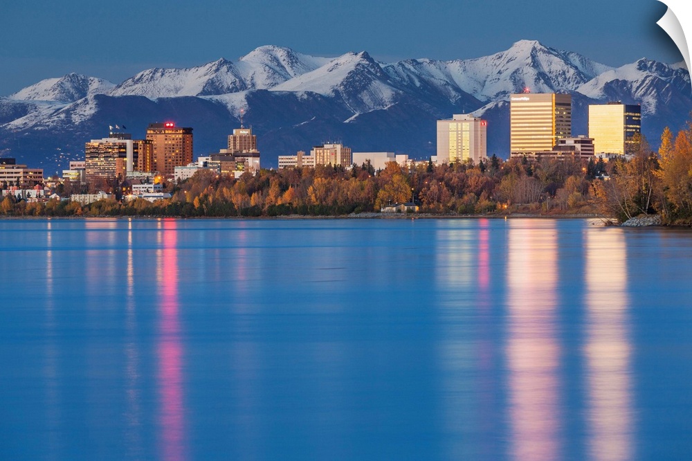 The Anchorage Skyline with the city lights reflected in the water of Knik Arm at high tide, Snow covered Chugach Mountain ...