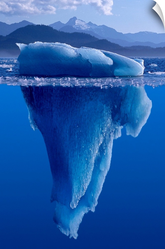 A composite photograph of a large Iceberg as seen from under and above the water.