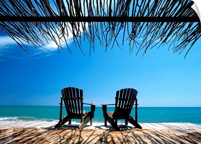 Two Chairs On Deck By Ocean Shaded By Grass Roof; Jamaica