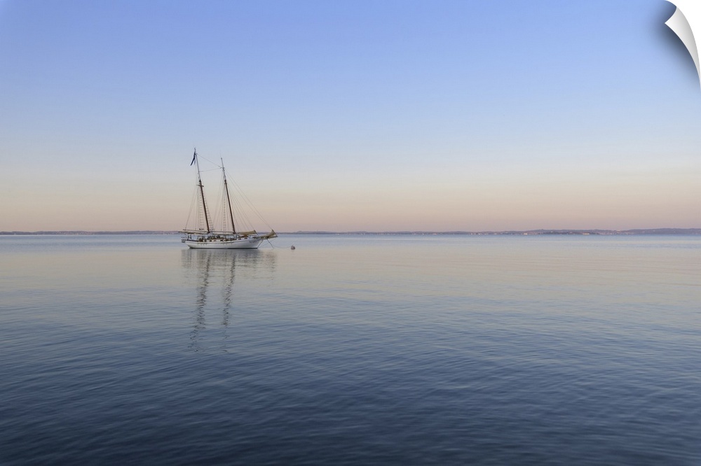 Two masted sailboat anchored on Lake Garda (Lago di Garda) at dawn at Bardolinoin Veneto, Italy