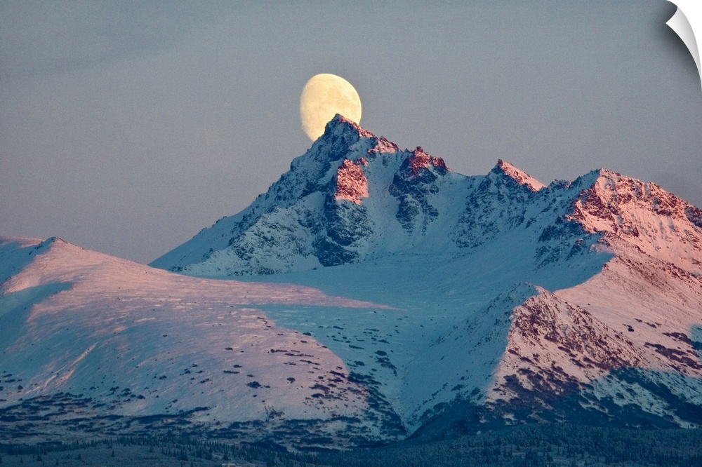 View of moon rising behind O'Malley Peak, Chugach Mountains, Anchorage, Southcentral Alaska, Winter
