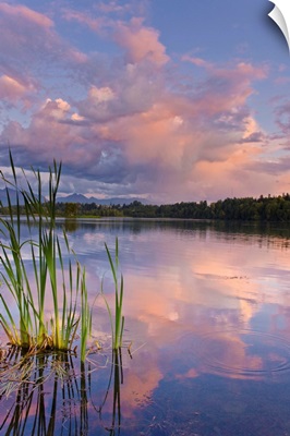 View of sunset clouds reflected in  Westchester Lagoon near downtown Anchorage