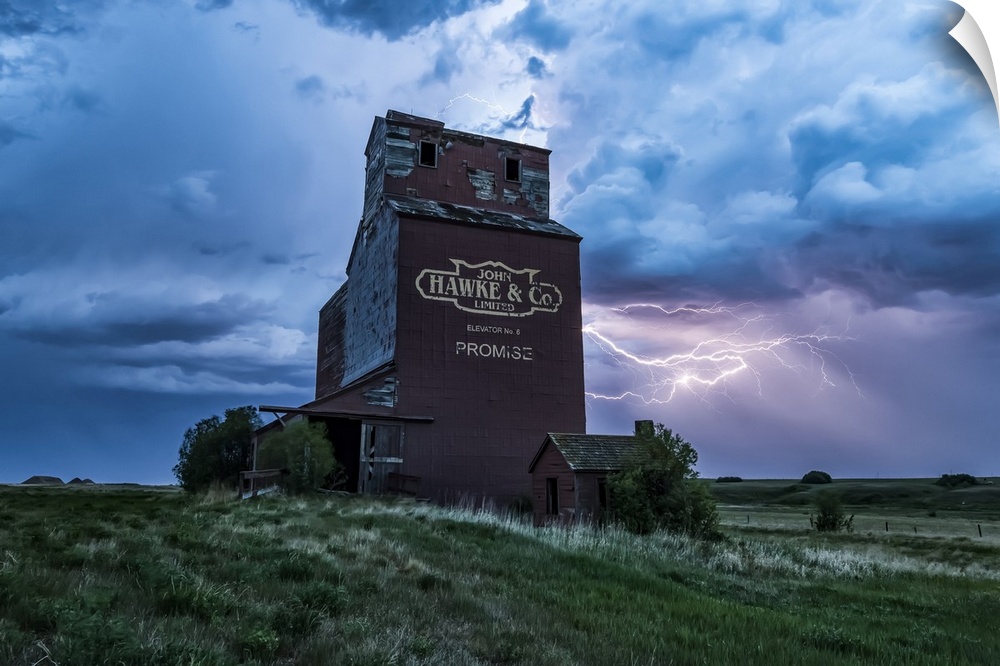 Weathered grain elevator and electrical storm on the prairies; Saskatchewan, Canada