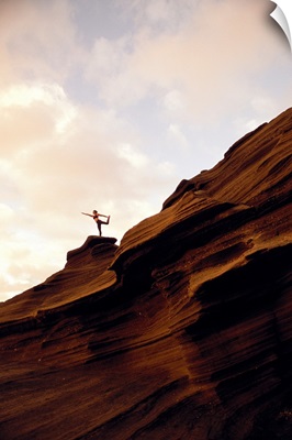 Woman Doing Yoga At Sunrise On Rock Coastline Cliff