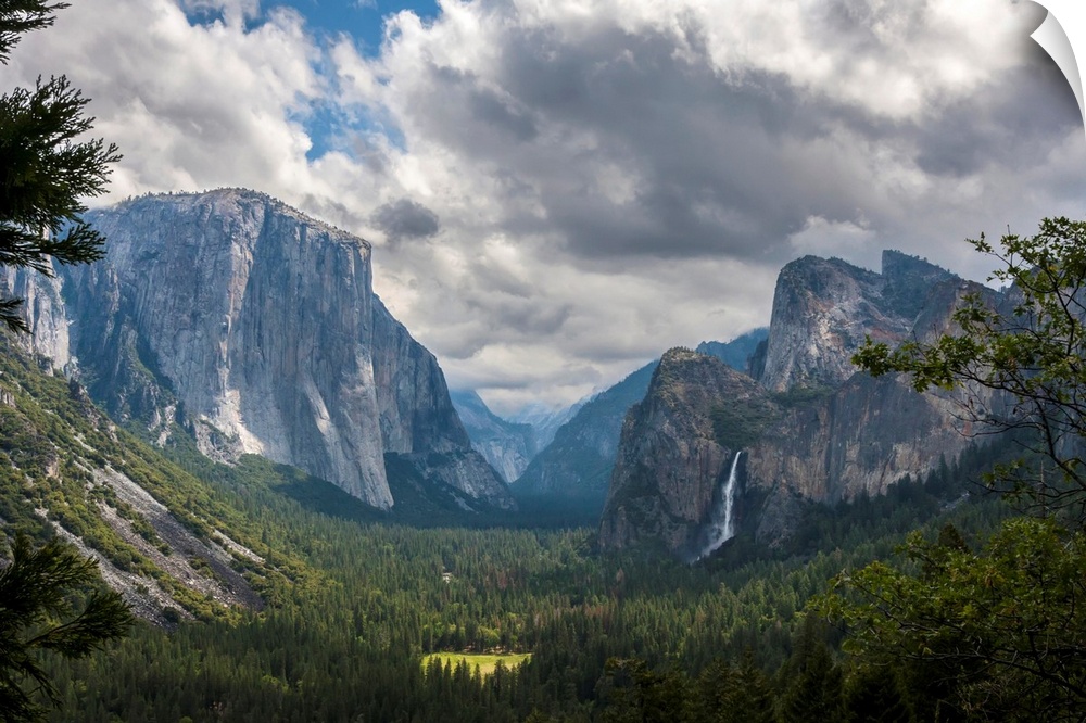 Clouds move over Yosemite Valley, with Bridalveil Falls on the right and El Capitan on the left, Yosemite National Park. C...