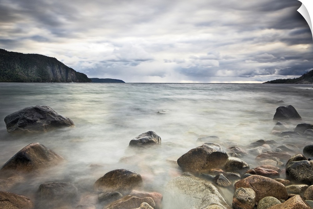 Fine art photograph of a rocky lakeshore under a cloudy sky in Ontario.