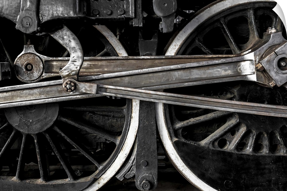 A close-up photograph of the wheels of a train.