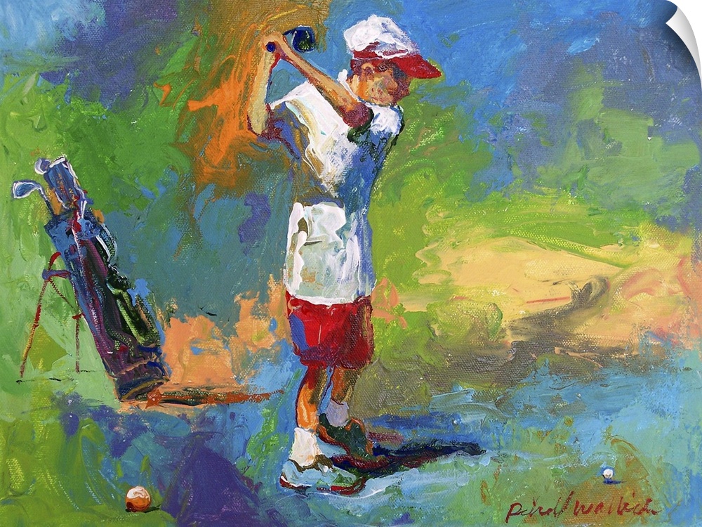 A young boy swinging at the golf ball.