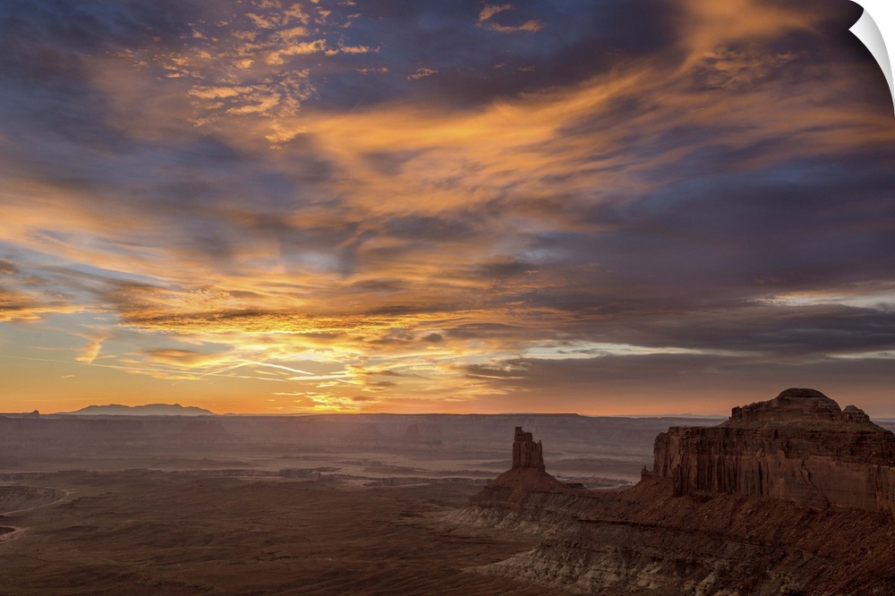 A photograph of desert landscape illuminated by a warm sunset.