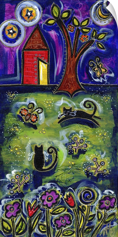 Two cats playing in a field at night.
