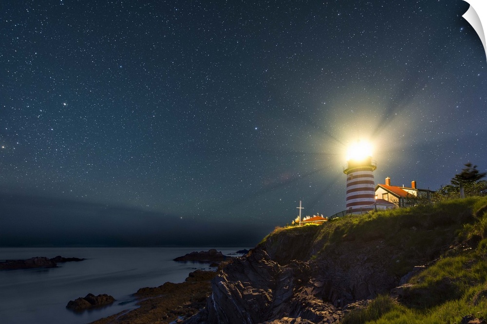 A photograph of a lighthouse under a starry night sky.