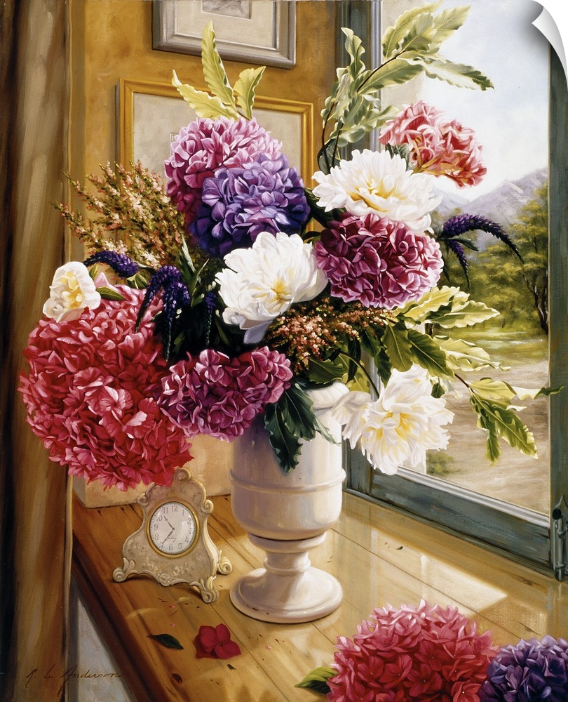 Bouquet of flowers in a tall white vase on a table with a vintage clock on it with a window overlooking a path.