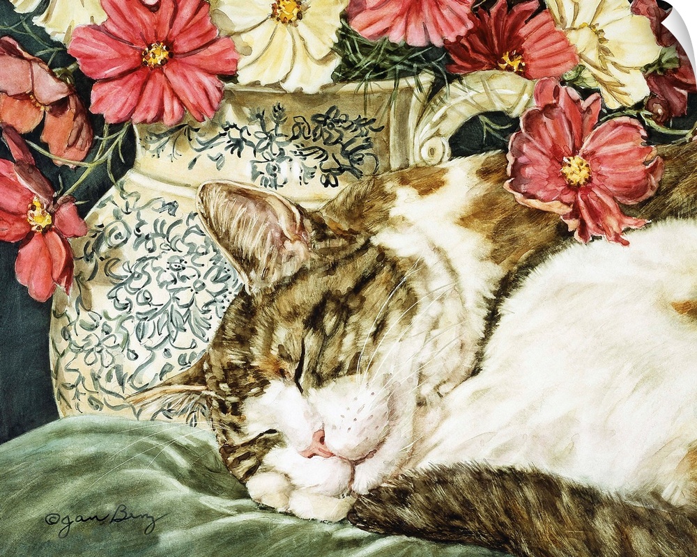 A cat sleeping on a pillow next to a vase of flowers.
