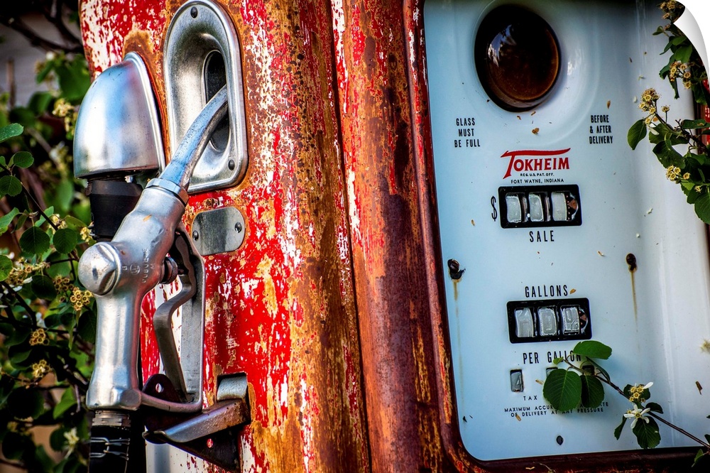 Photograph of an old, rusted, antique gas pump.