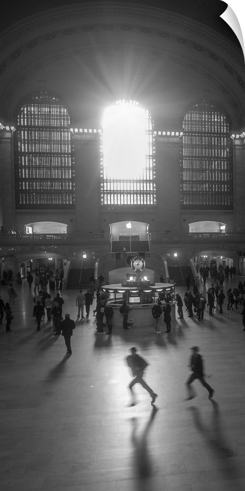 An artistic black and white photograph of silhouetted people inside Grand Central Station.