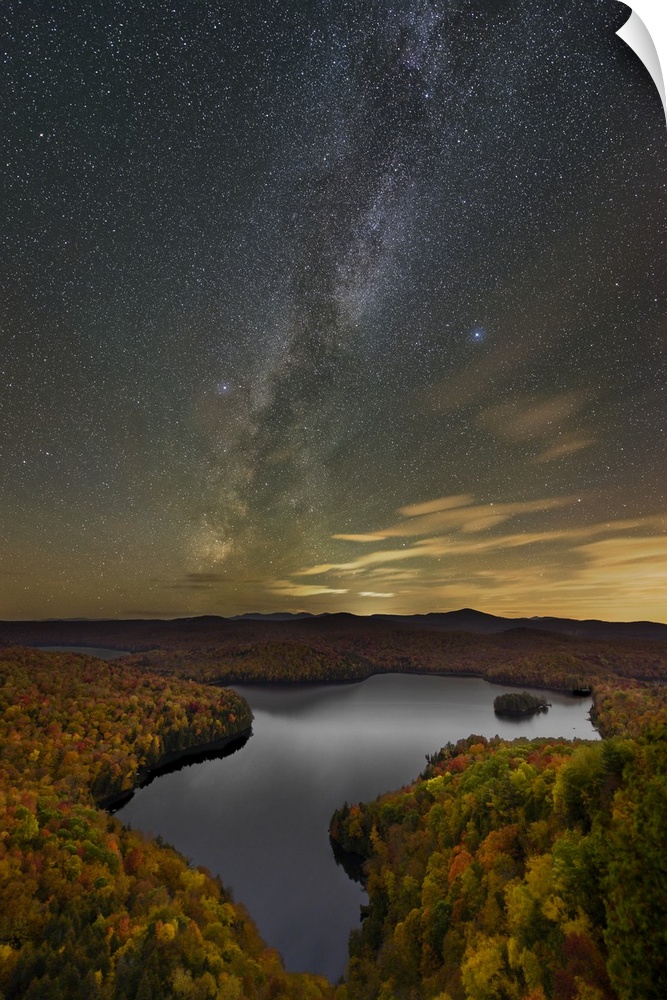 A photograph of a serene wilderness landscape under a night sky.