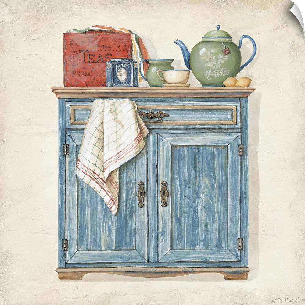 Sideboard cabinet with teapot, box of teas, creamer, teacup and towel.