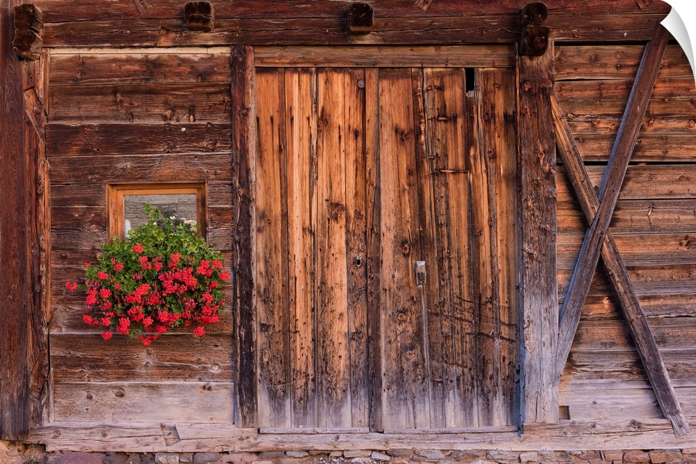 A photograph of weathered wood on the exterior of an old barn.
