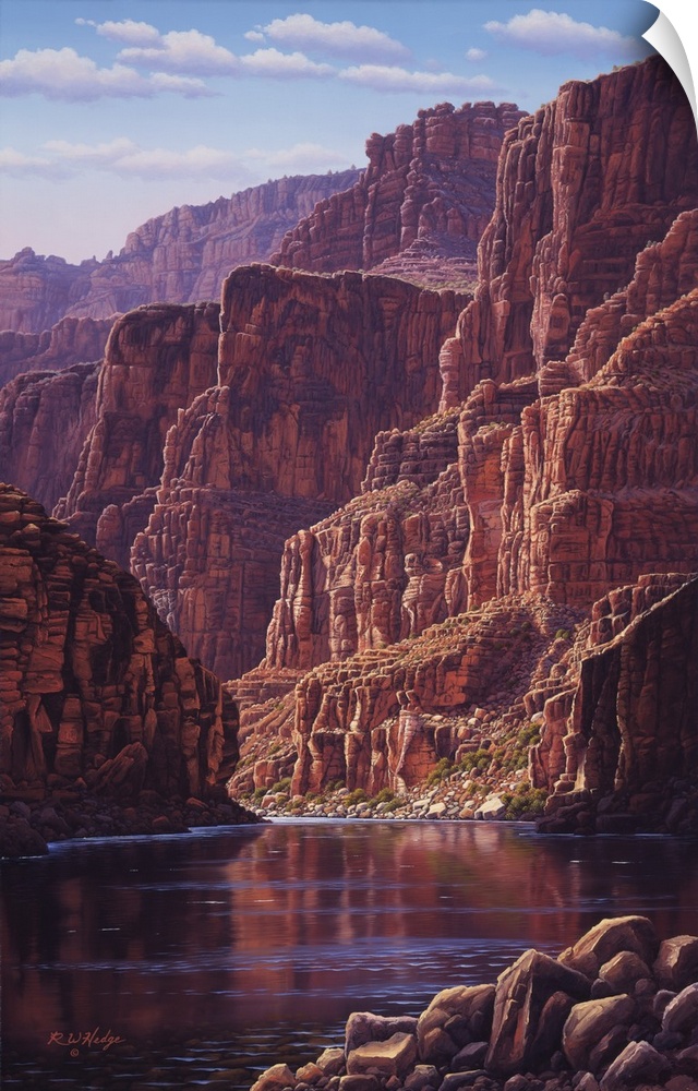 A calm river flows through the bottom of a canyon.
