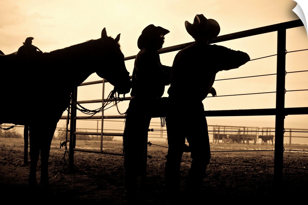 2 cowboys talking at the corral