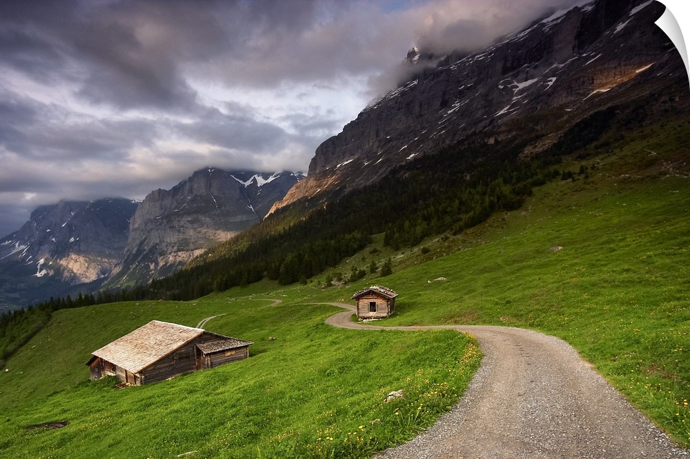A photograph of the roof of a cottage in a dreary mountainous valley landscape.