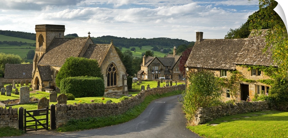 A quaint countryside village with cottages and stone fences.