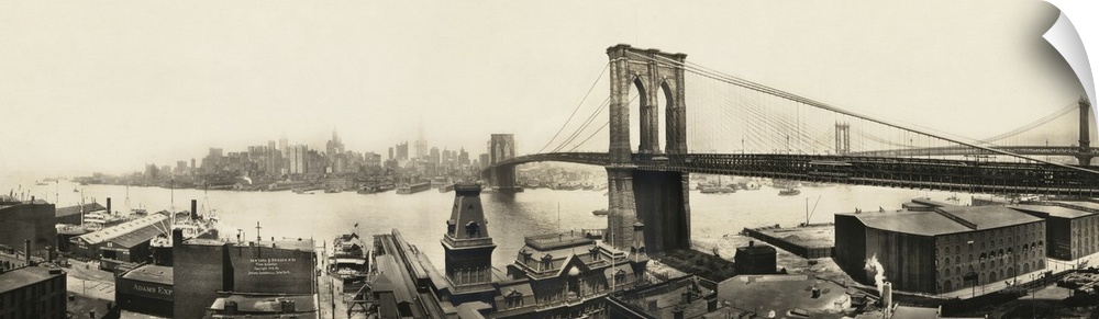 A vintage photograph of a the Brooklyn bridge spanning the East River toward Manhattan.