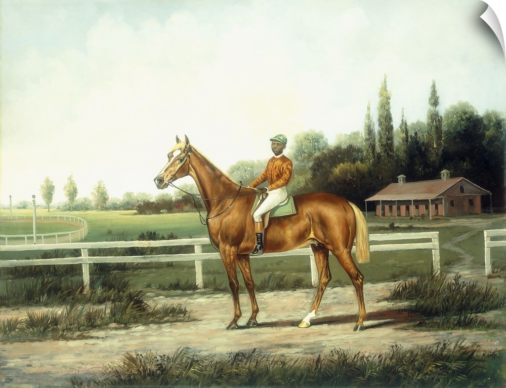 A Chestnut Racehorse with Jockey Up on a Training Track with Stables Beyond