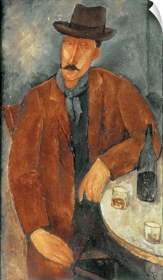 A seated man leaning on a table