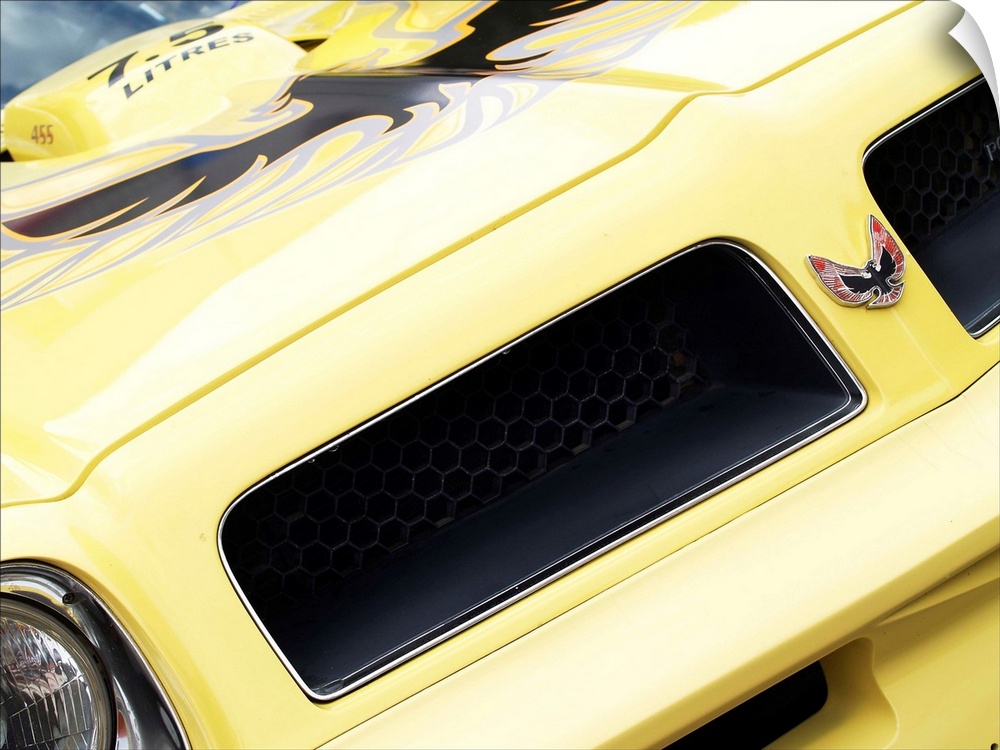 Angled photograph of the front of a yellow 1976 Pontiac Trans Am.