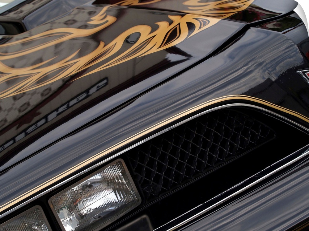Angled photograph of the front of a black and gold 1978 Pontiac Trans Am.