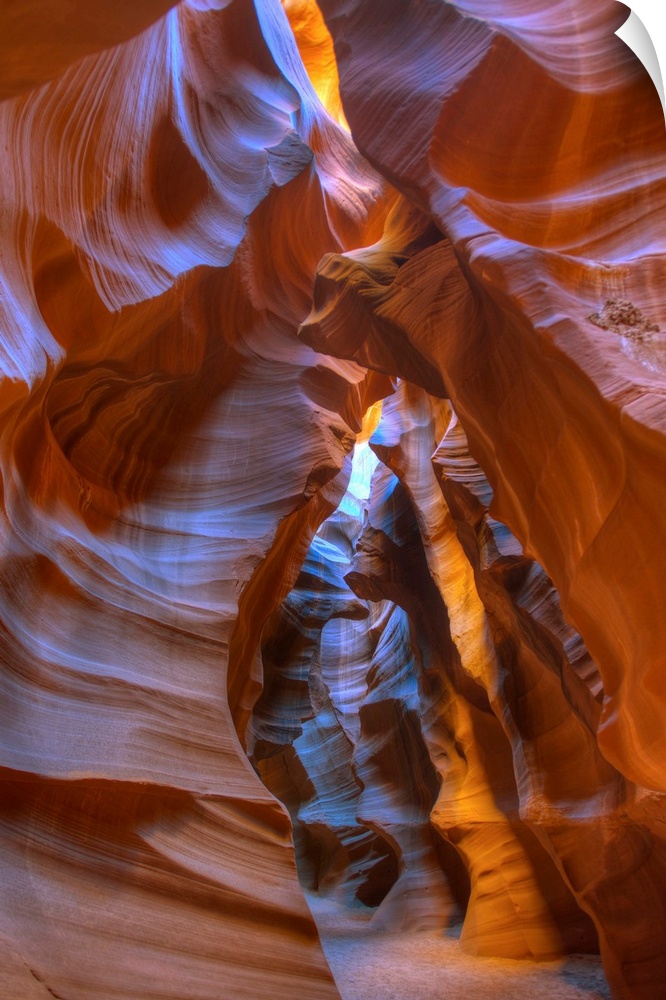Photograph inside Antelope Canyon with the sun peaking in through the cracks.