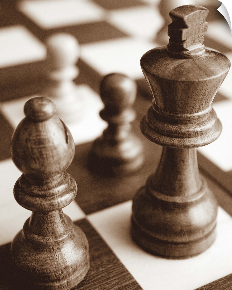 Sepia toned photo of chess pieces on a game board.
