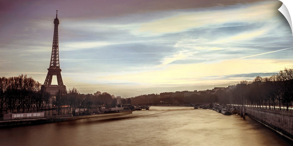 Panoramic image of Paris with the Eiffel tower and Seine River in the evening.