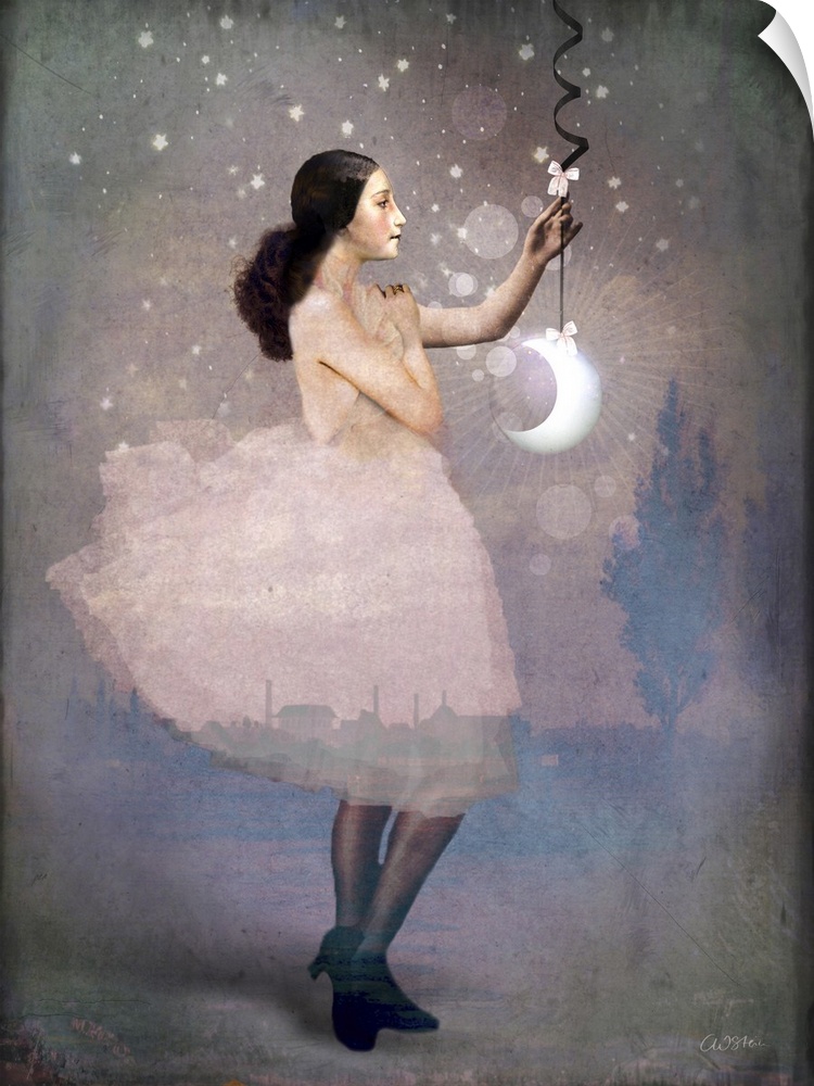 A lady in pink is holding a crescent moon hanging from a ribbon.