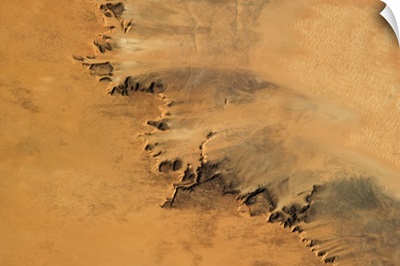 Arid fingers of sand-blasted rock in the hot Saharan wind