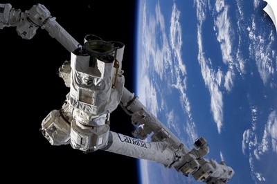 Canadarm, the Earth, and the tiny crescent Moon - a still life