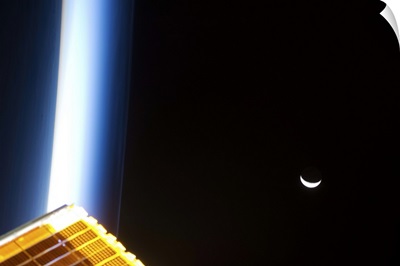 The Moon at sunrise, with blue noctilucent clouds and a solar array glowing gold