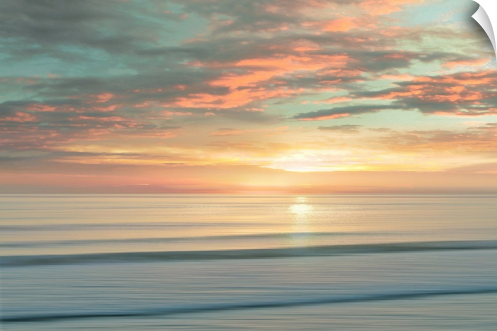 A peaceful scene of the sun slowly rising over a calm stretch of ocean. The sky glows in shades of apricot and light teal....