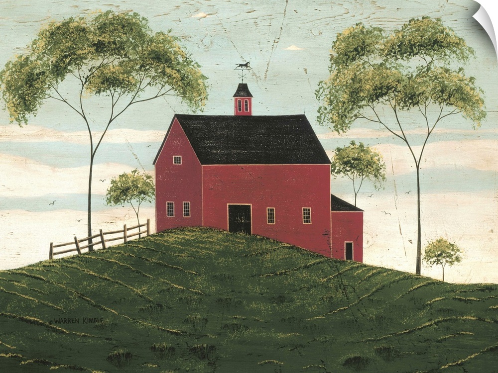 A large barn is painted sitting on a hill and surrounded by two very tall trees and some smaller.