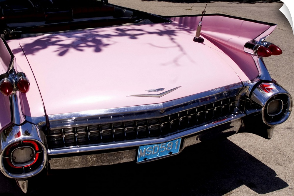 Classic 1959 pink Cadillac convertible on road in beautiful Varadero Beach in Valadero Cuba