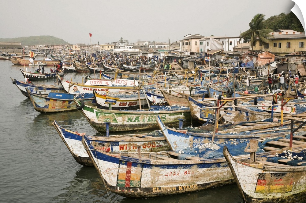 Africa, West Africa, Ghana, Elmina. Colorful hand-painted fishing boats tied up at Elmina port.